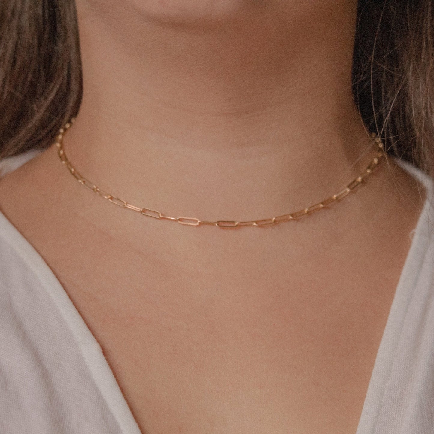gold paperclip choker on