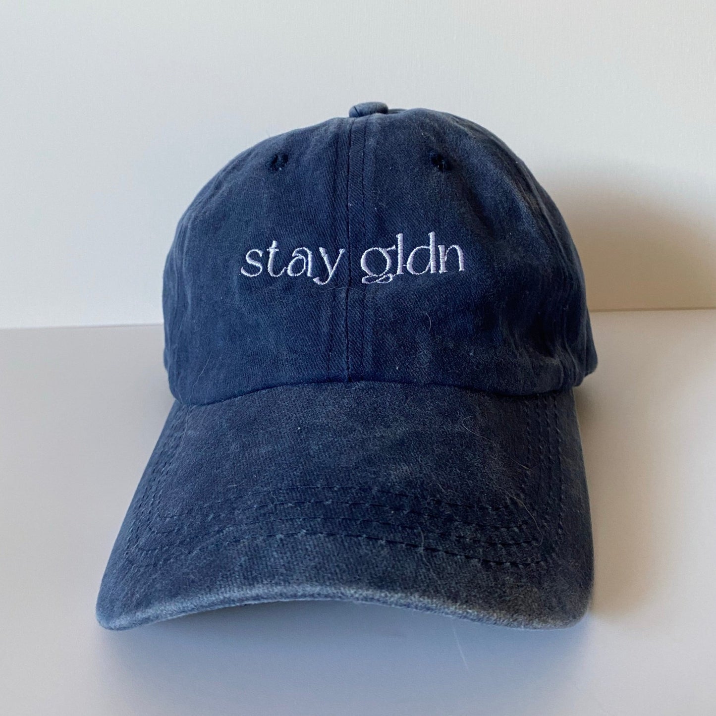 
                  
                    stay gldn hat
                  
                